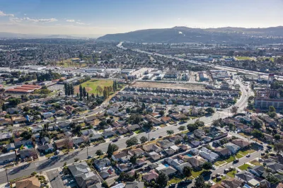 Aerial view of low-rise neighborhood near ocean in South Bay, Los Angeles, California.