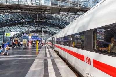 White and red DM high-speed rail train at platform in large train station in Berlin, Germany.