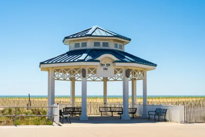 White gazebo with blue roof next to beach in Sea Isle City, New Jersey.
