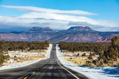 Asphalt road heading toward Bears Ears National Monument in Utah in winter.
