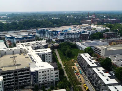 Aerial view of Atlanta BeltLine trail with colorful outdoor patio umbrellas and buildings.