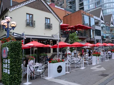 Outdoor dining patio with red umbrellas in Toronto, Canada