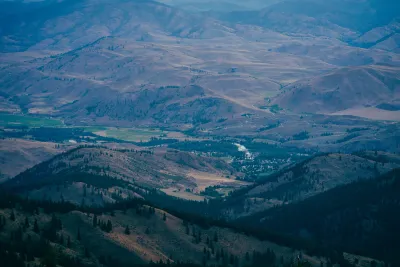Aerial view of small rural community nestled in sprawling green valley in Washington State