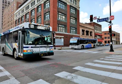 City bus in downtown Kansas City with brick buildings in background.