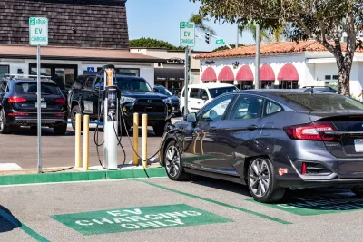 Car parked at EV charging station in parking lot in Carlsbad, California.