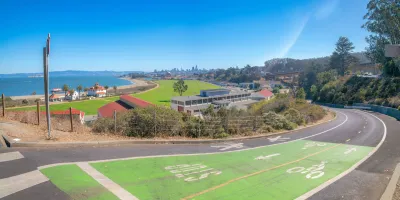 Green painted bike and pedestrian trail with view of San Francisco Bay.
