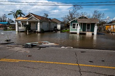 Two small wood homes with floodwaters in coastal Louisiana after Hurricane Ida.