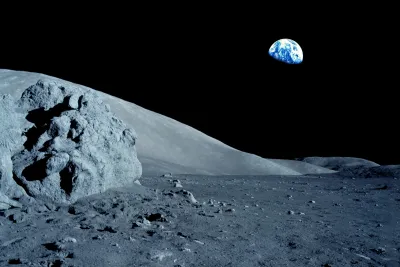 Gray moon surface with black sky and Earth in the background.