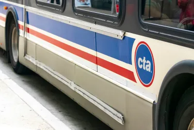 Close-up of side of white and blue and red Chicago Transit Authority bus.