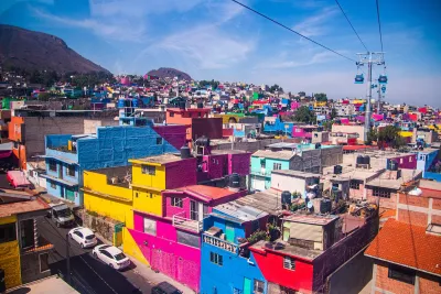 View of colorful dense buildings in Mexico City from aerial cable car.