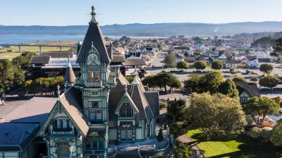 Ornate Victorian home in foreground and neighborhood in Eureka, California.