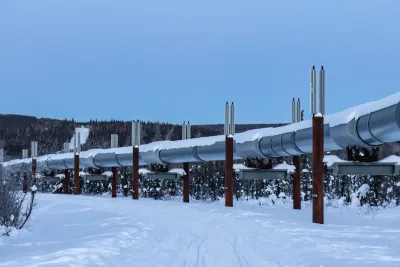 Silver oil pipeline running above ground in snowy area near Fairbanks, Alaska.