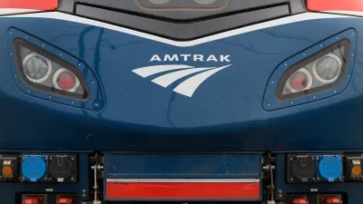 Close-up of front of blue locomotive with Amtrak logo.