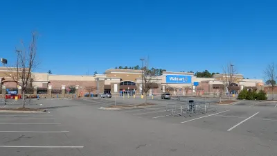 Large Walmart store with empty parking lot.