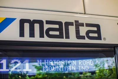 Close-up of MARTA logo on side of white city bus in Atlanta, Georgia.