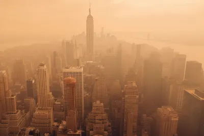 Aerial view of New York City including Empire State Building blanketed in orange wildfire smoke
