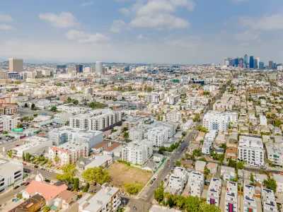 Aerial view of Koreatown neighborhood in Los Angeles with downtown skyline in background.