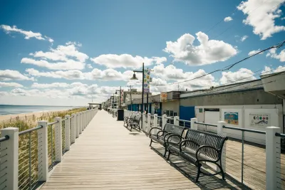 Wooden beachside boardwalk with benches in Salisbury, Massachusetts.