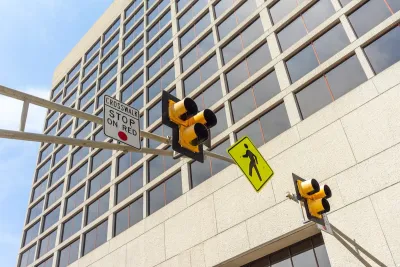 Low angle view of a pedestrian crosswalk traffic signal lights in a city.