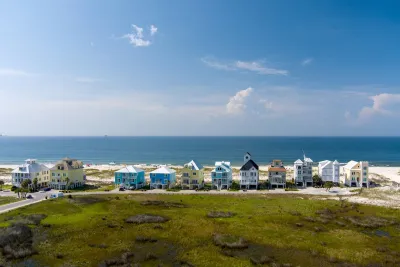 Row of colorful two-story beach homes on Gulf Coast beach in Alabama.