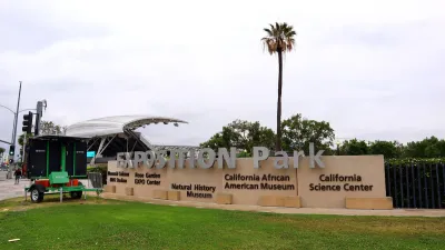 Expositoin park enrtance sign in Los Angeles, California with tall palm tree in background.