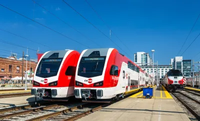 Two red and white electric trains, part of Caltrain fleet in San Francisco, California.