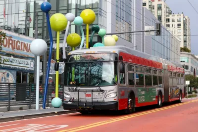 Muni bus on red painted bus-only lane in downtown San Francisco, California.