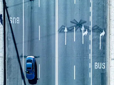Bird's eye view of multi-lane road with dedicated bus lanes.