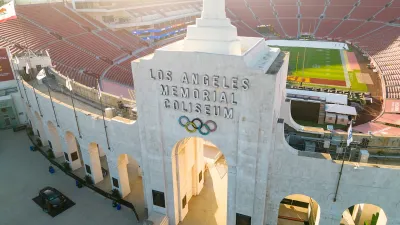 Aerial view of Los Angeles Memorial Coliseum entrance arch with name and Olympic rings.