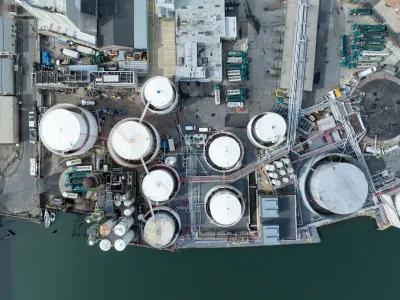Bird's eye view of water treatment plant next to water body.