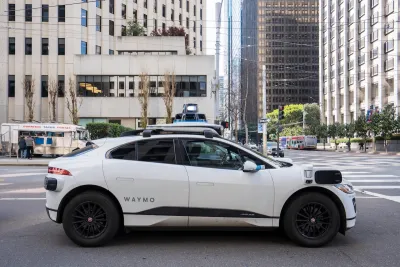 White Waymo autonomous SUV taxi on San Francisco street.