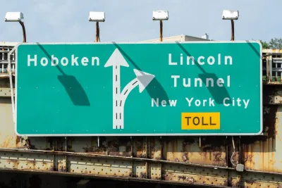 Close-up of green and white sign for Lincoln Tunnel and Hoboken.