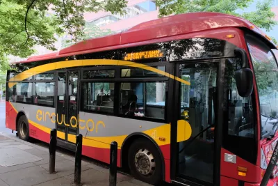 Red Washington, D.C. Metrobus Circulator bus parked at stop near Dupont Circle, Washington, D.C.