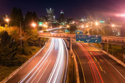 View of blurred traffic lights on Interstate 5 freeway heading into Portland, Oregon at night.