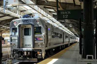 New Jersey Transit passenger rail commuter train at station in Hoboken, New Jersey with platform 12 sign.