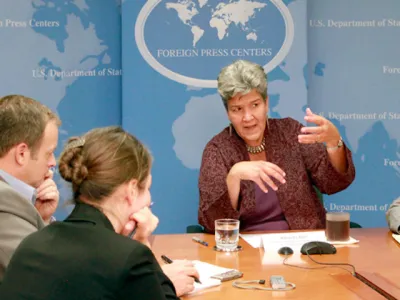 I picture of Marisa Lago speaking at a table for an event at the United Nations.