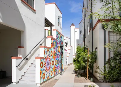 Colorful two-story buildings close to each other in Culdesac Tempe development.