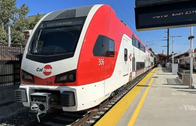 Red and white Caltrain electric train at platform in San Jose, California.