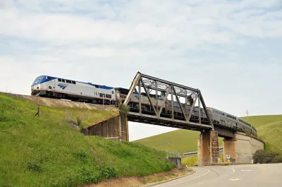 Amtrak Coast Starlight passenger train passing over bridge in Altamont Pass, California.