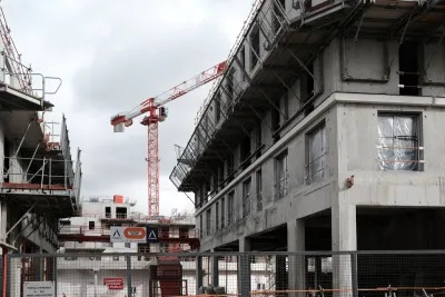 Cranes rise into the sky on a construction site for an office and housing building for the Bouygues Group in the southern suburbs of Paris.