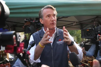 Glenn Youngkin gesturing with his hands while speaking to the media and the public while campaigning for governor of Virginia at the Alexandria Farmers Market.