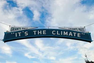 "It's The Climate" sign over street in Grants Pass, Oregon.