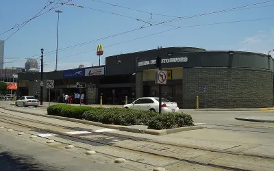 Greyhound bus station in Houston, Texas next to street with light rail tracks.