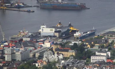 Dokken is a western part of the Port of Bergen (Norway). At Dokken is the large, white Port Warehouse, in which a small brown/black building (in the center of this image) is the WWII German anti-aircraft artillery bunker (RK-ID 212746).