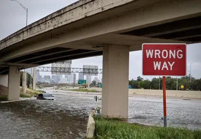 Flooded freeway underpass with red and white WRONG WAY sign in Houston, Texas during Hurricane Beryl in July 2024.