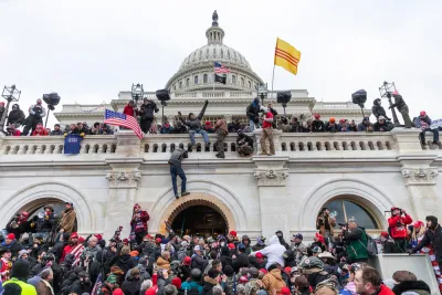 Trump supporting insurrectionists scale the walls of the U.S. Capitol Building on January 6, 2021.