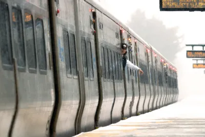 A train conductor waves at an empty platform on the Long island Rail Road system.