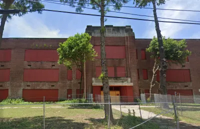 Google street view of vacant, boarded-up brick high school building in Memphis, Tennessee.