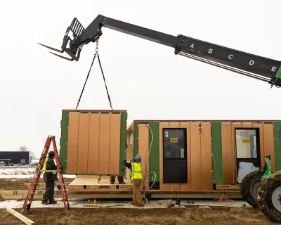 Modular housing being installed with crane.