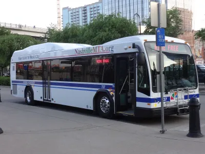 Nashville MTA transit bus at station on street.